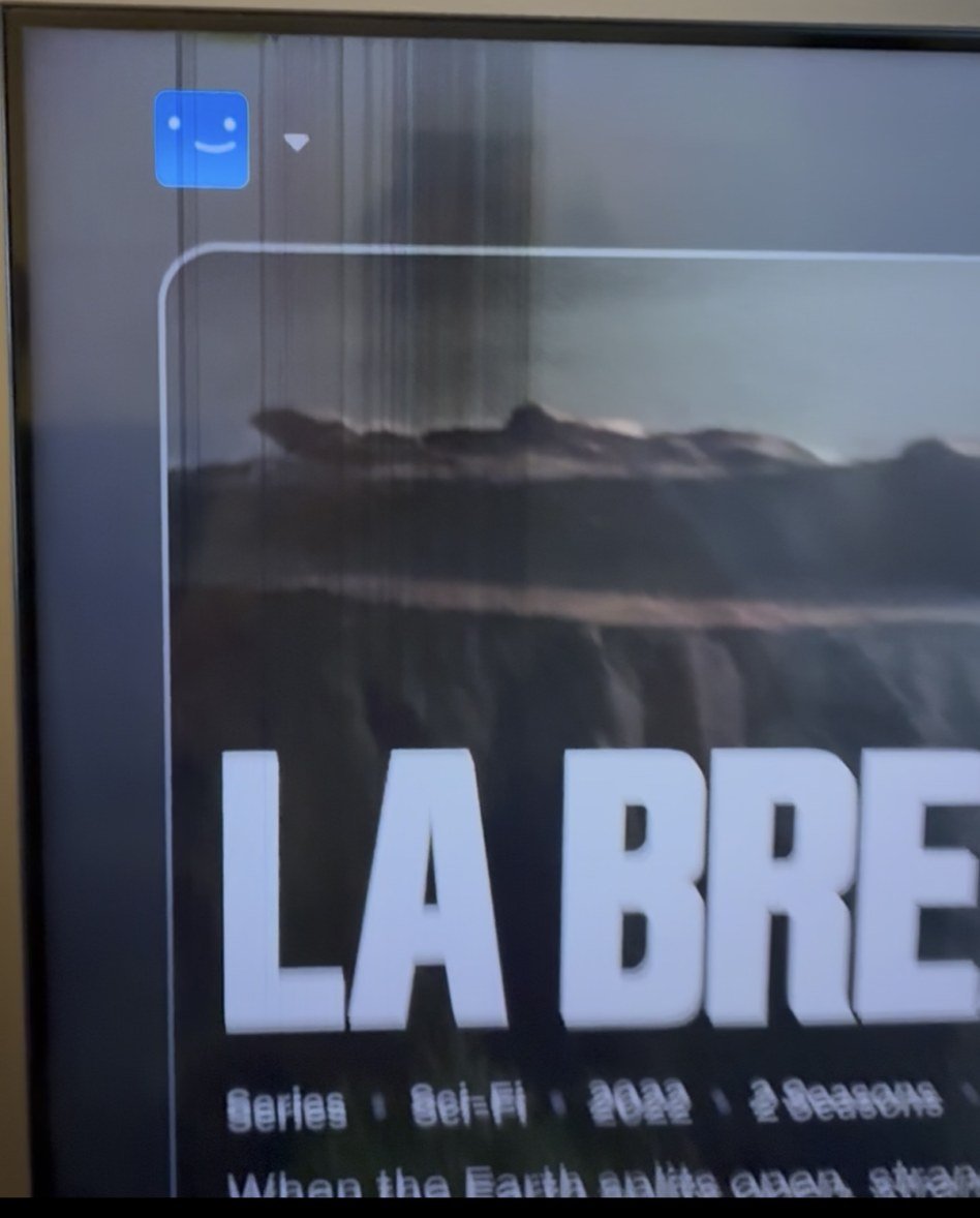 The same television in month 22, showing vertical lines and a dark band across the picture